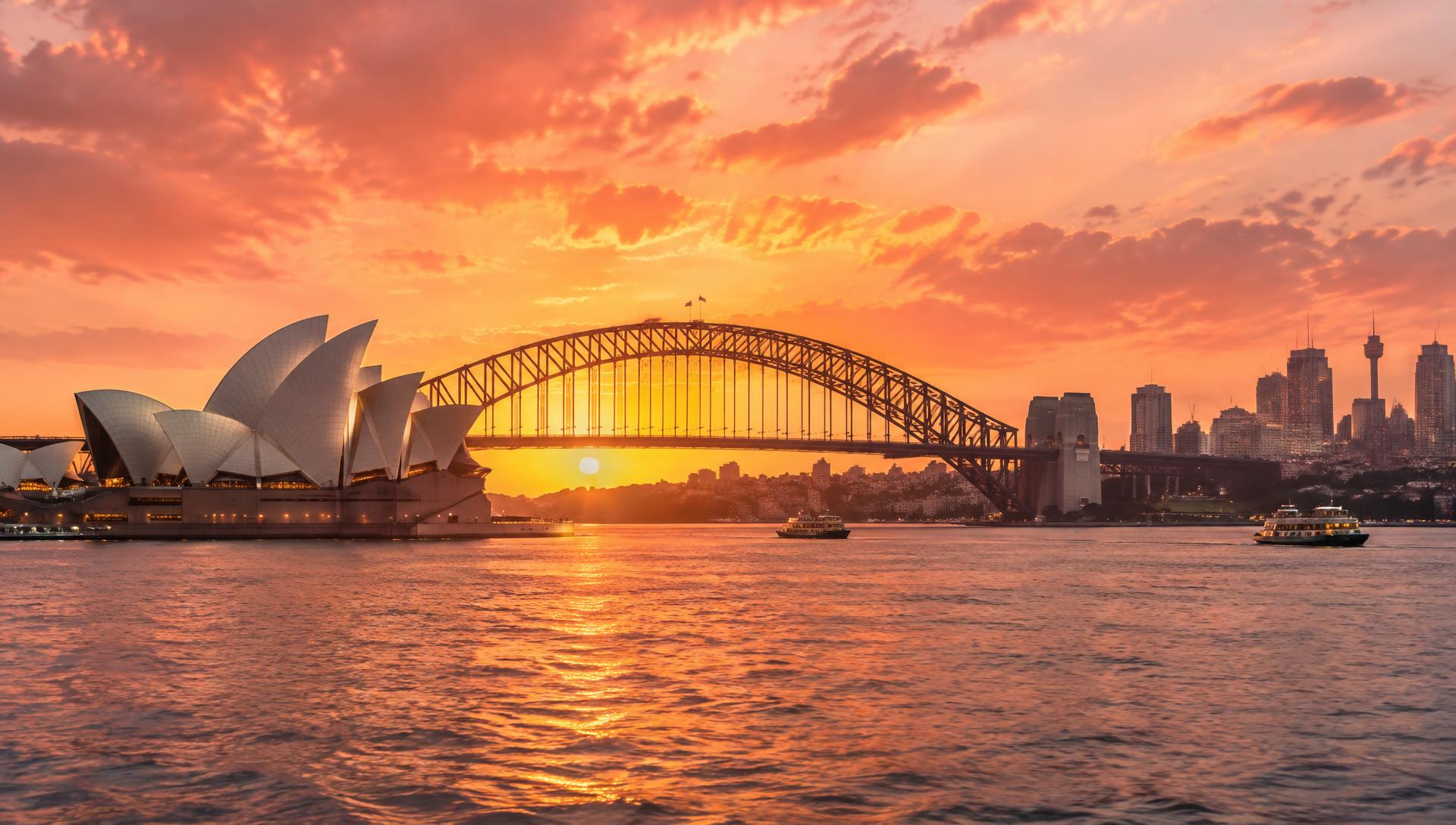 Sydney Harbour at sunset with the Opera House and Harbour Bridge